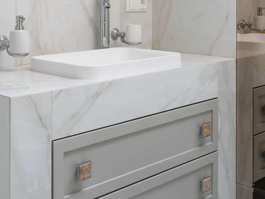 Custom bathroom vanity with a stone countertop and framed mirror