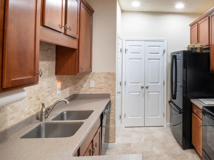 Kitchen with honey oak cabinets and a double stainless sink