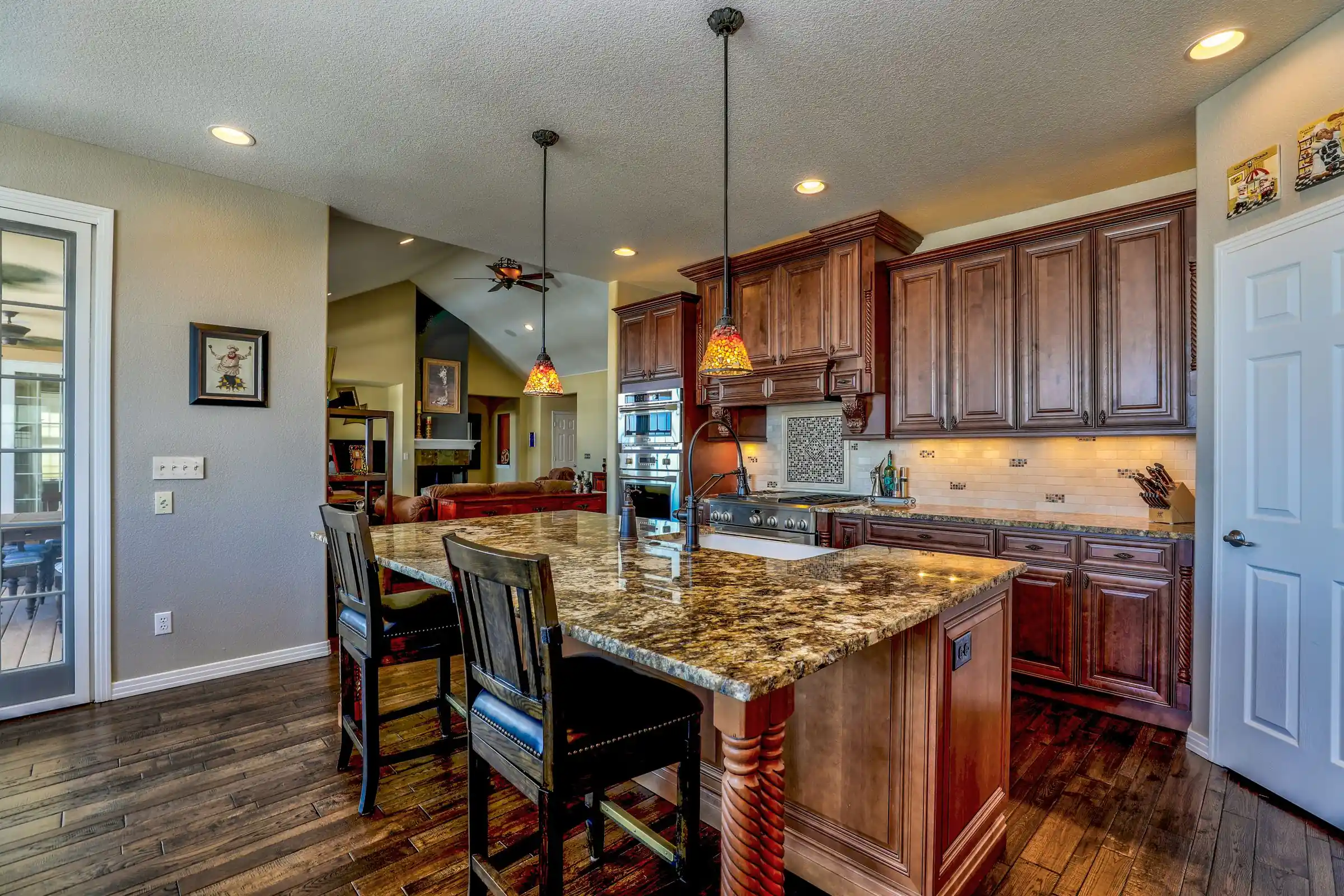 Traditional cherry kitchen with a granite island and pendant lights